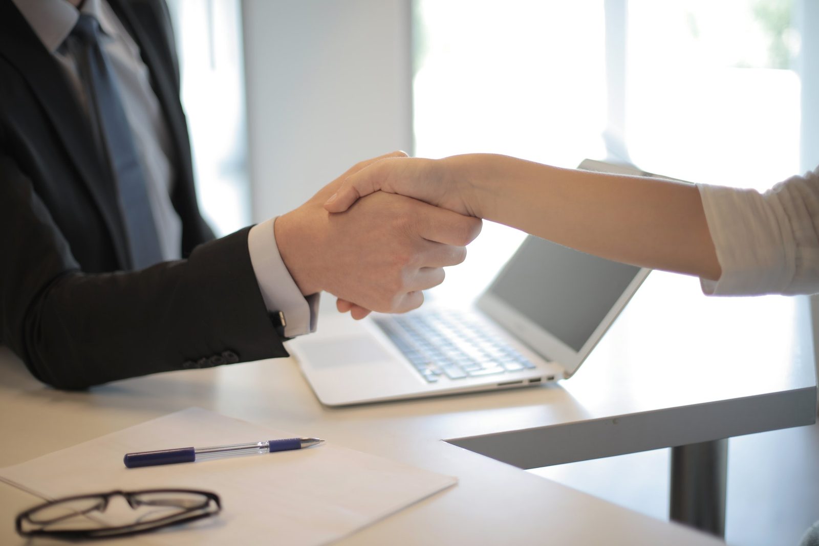 A Summit 13 consultant meeting a client across an office desk