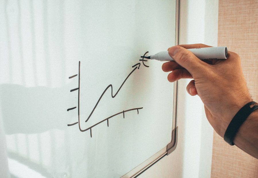 Sketching a rising growth curve on a whiteboard