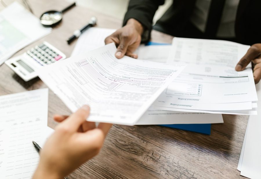 Working through printed tax return forms with a calculator